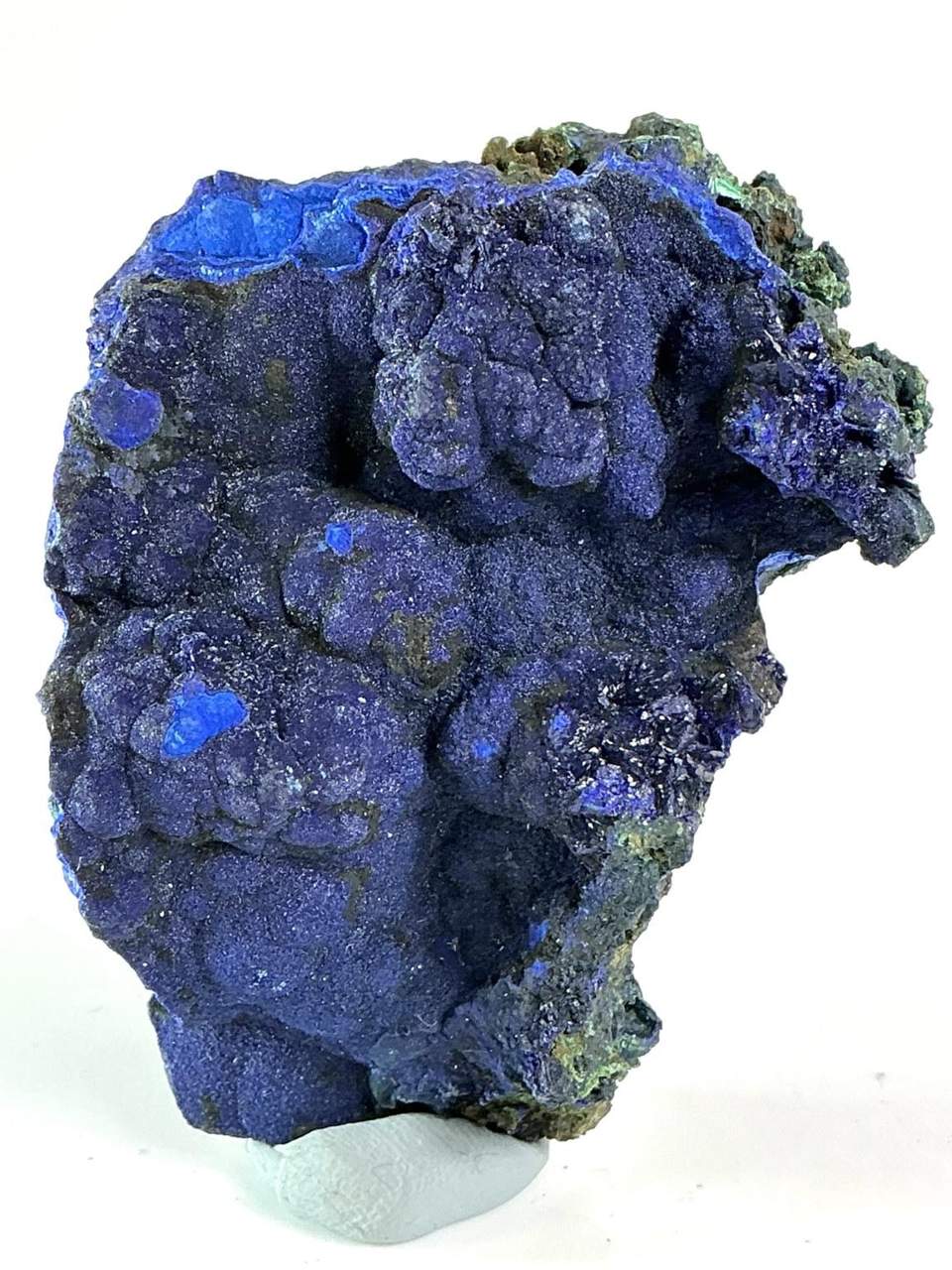 Rounded purple-blue Azurite growths with brighter cobalt-blue patches on natural matrix