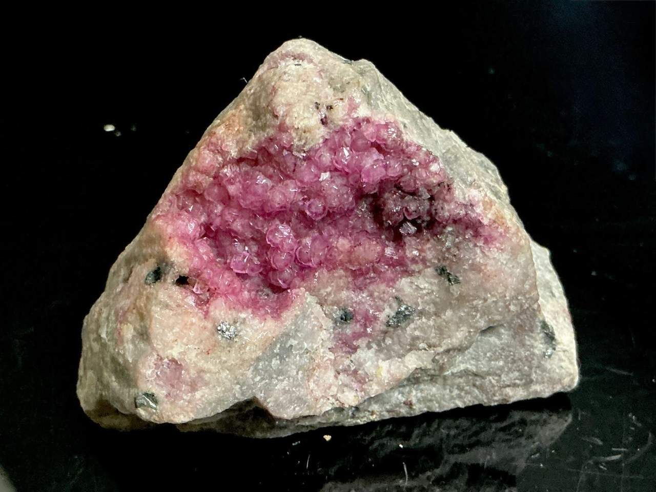 Raspberry-pink Cobaltoan Calcite crystals lining a cavity with metallic grains on matrix from Kolwezi