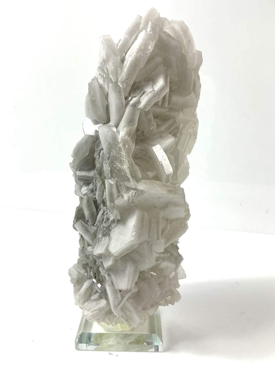 Fluorescent “Poker Chip” Calcite on Matrix on a bevelled glass base