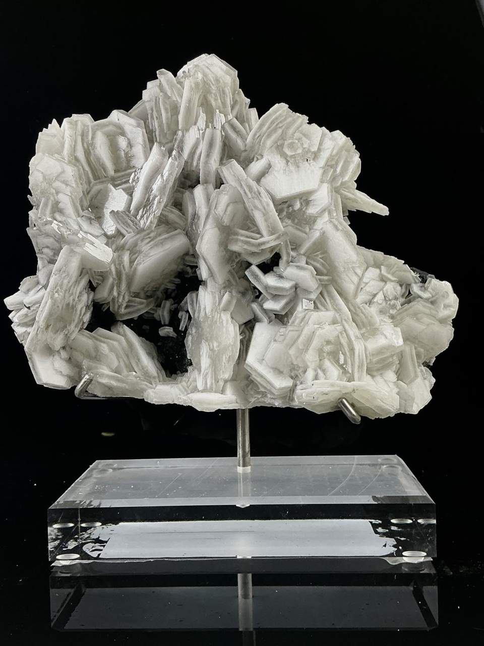 Manganese-bearing poker chip Calcite cluster on limestone matrix, mounted on a clear acrylic display base